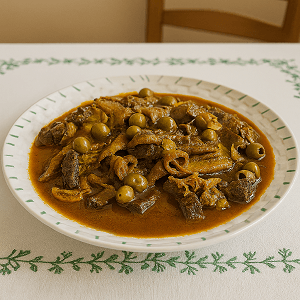 authentic Moroccan festive stew with tender meat, green olives, and rich sauce served in a white plate with green patterns on a white embroidered tablecloth.